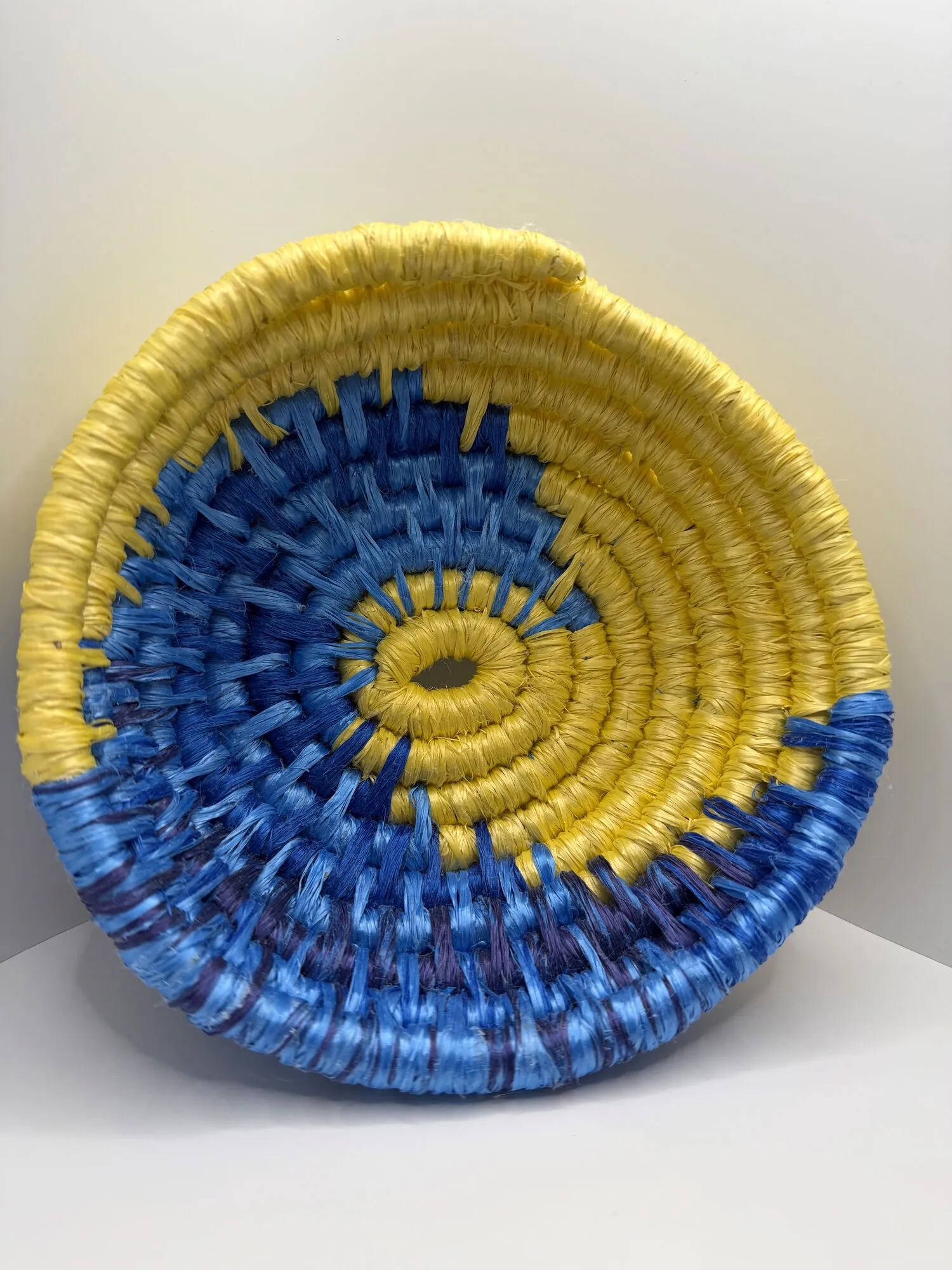 Shallow rope bowl swirled in blue and yellow