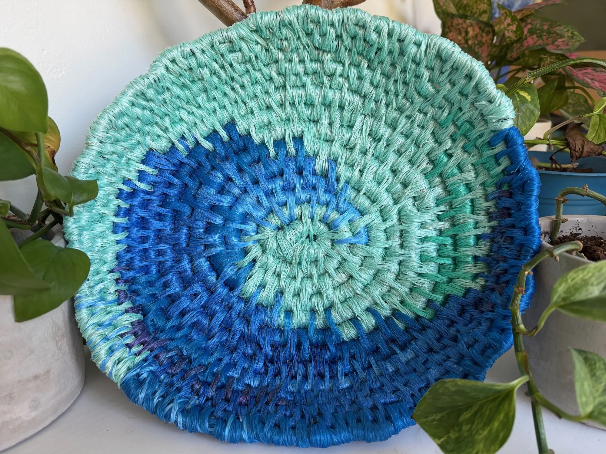 Coiled rope platter swirling from aqua to deep blue