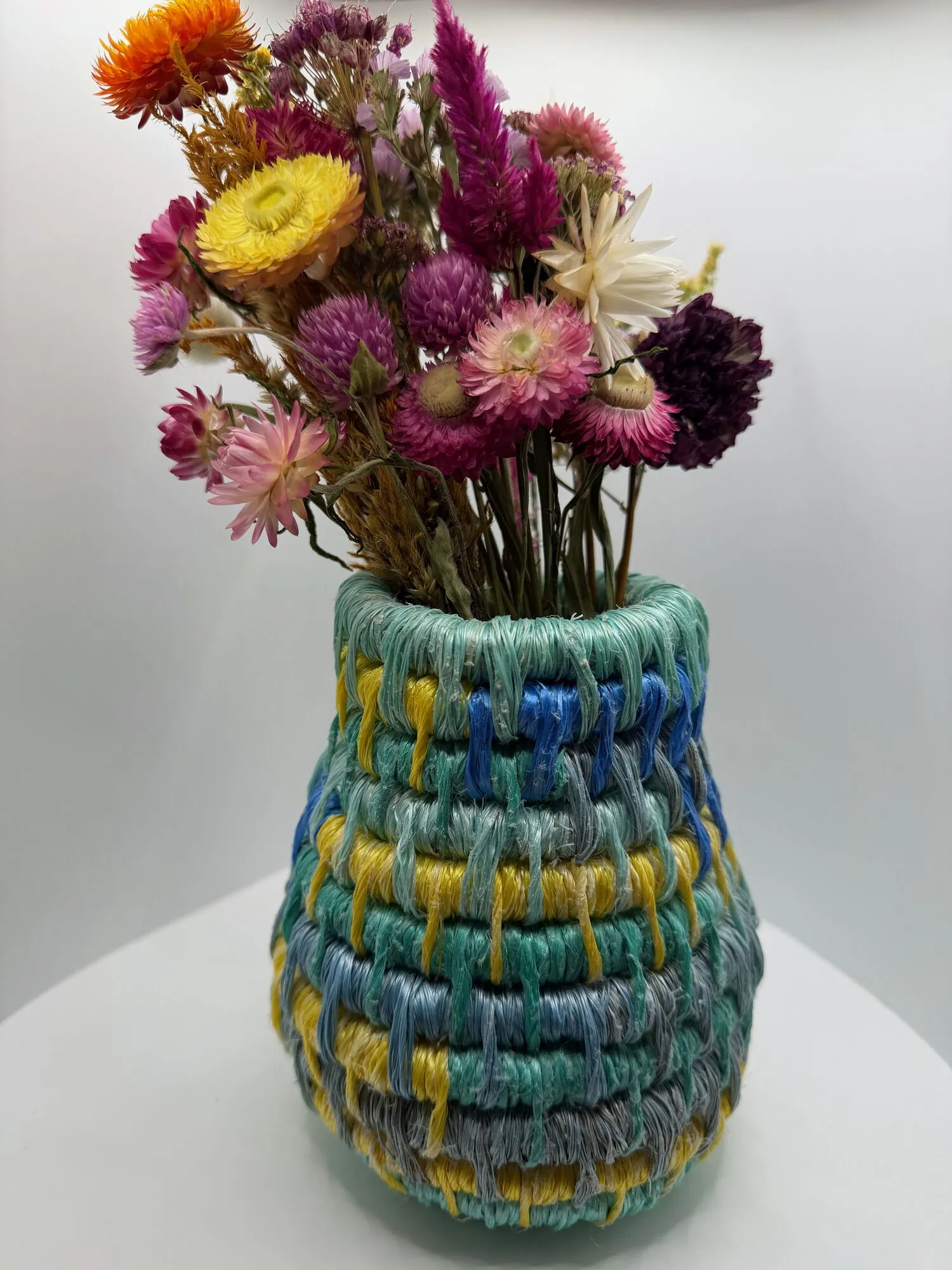 Sea-glass colored rope vase with dried flowers