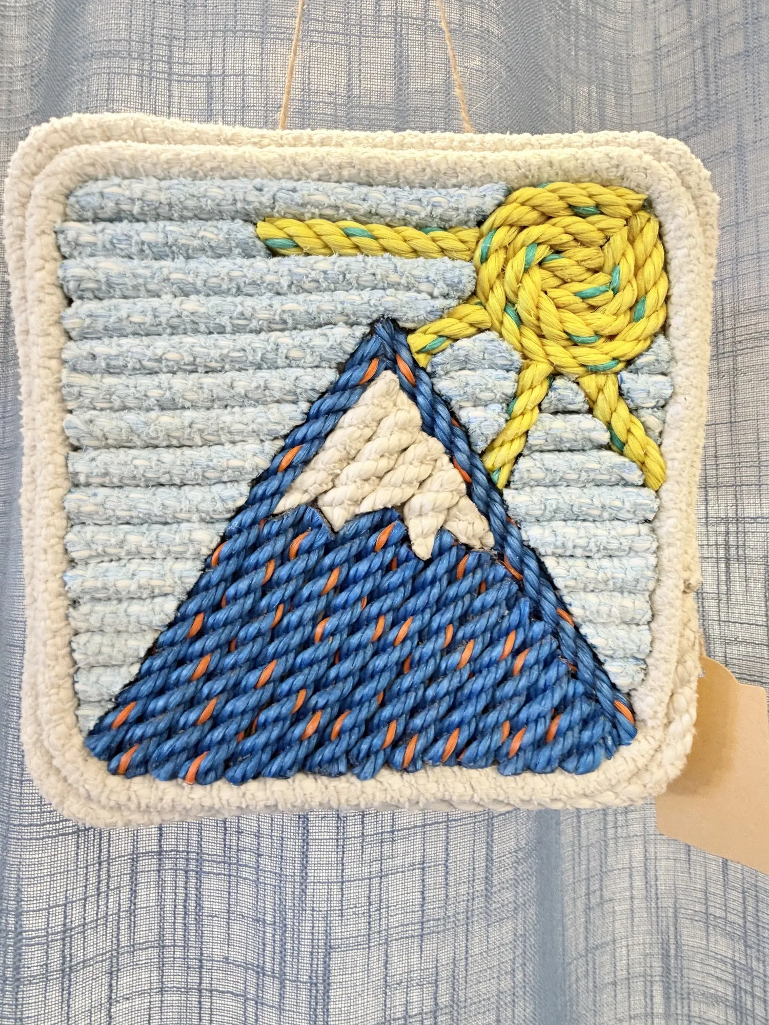 Square rope wall art of a snowcapped Sugarloaf mountain in blue, with a yellow sun in a pale blue sky